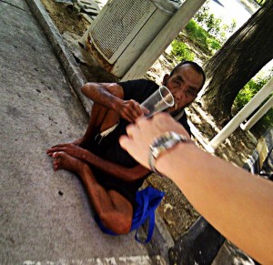 Elder, homeless and begging in the heart of capitalistic Kuala Lumpur.