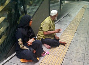 This couple does not appear to be hungry or homeless, but they were begging near KL Sentral.